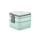 Close-up of the green plastic stackable lunch box, open to show compartments.