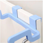 Plastic garbage bag holder conveniently attached to a kitchen cabinet door.