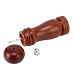 Detailed view of the wooden pepper mill's base, highlighting the durable ceramic grinding mechanism.