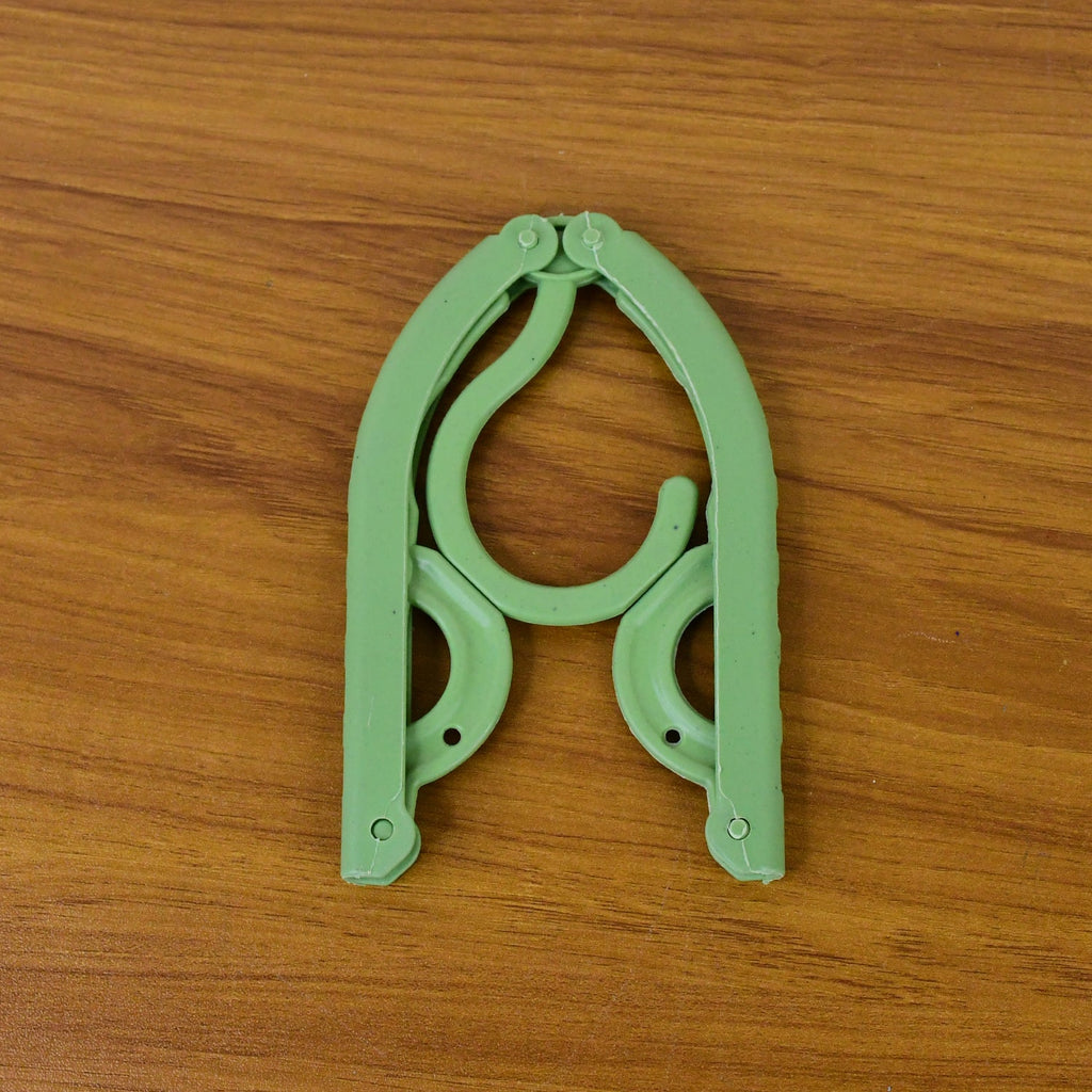 Portable foldable travel hanger holding clothes securely during trips
