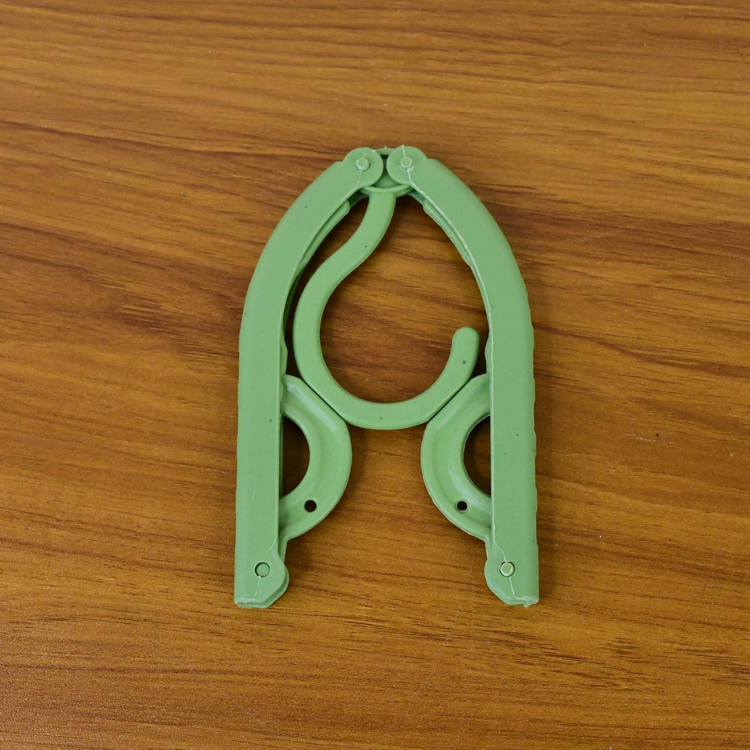 Portable foldable travel hanger holding clothes securely during trips
