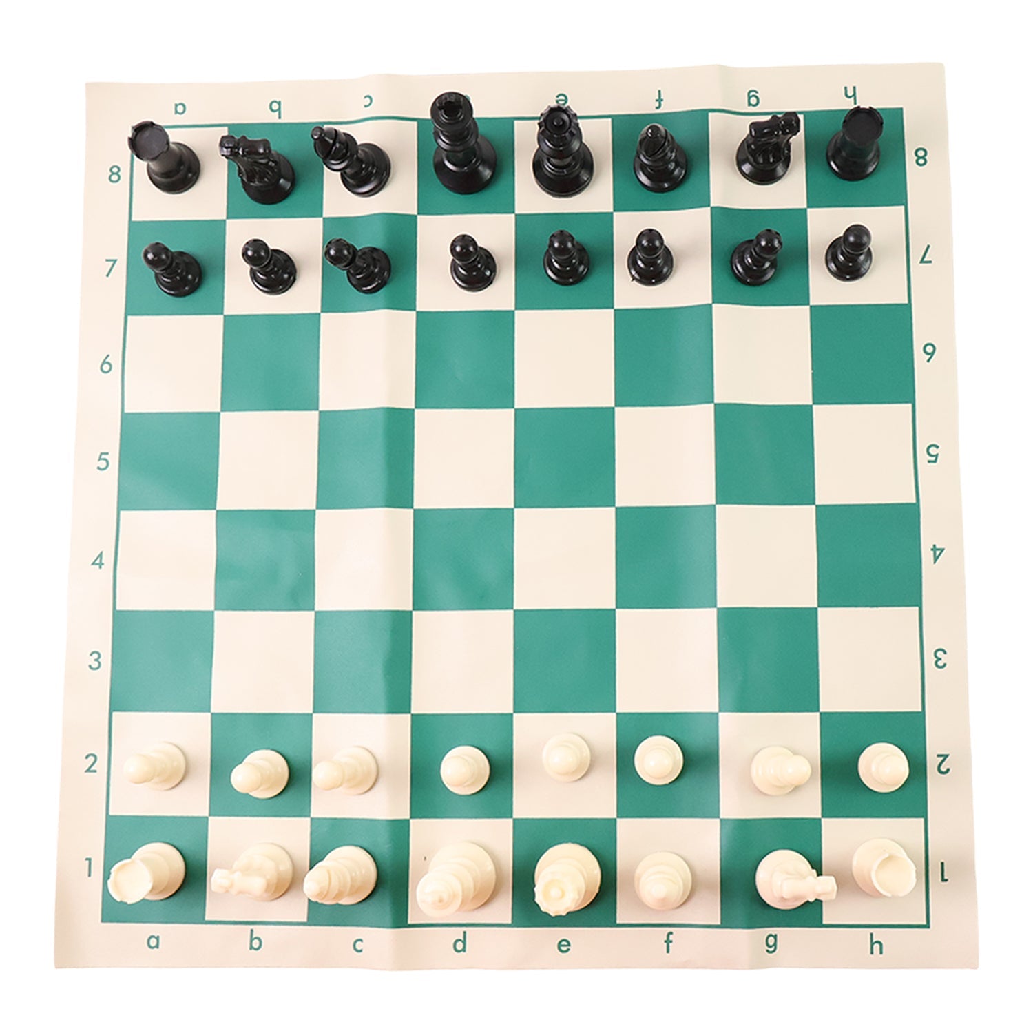 Plastic chess set pieces arranged on the roll-up green and white chess board