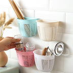 Back view of the hanging plastic storage basket, highlighting its adhesive strip for wall mounting.