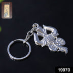 Close-up of intricate silver Trishul and Damru details on keychain