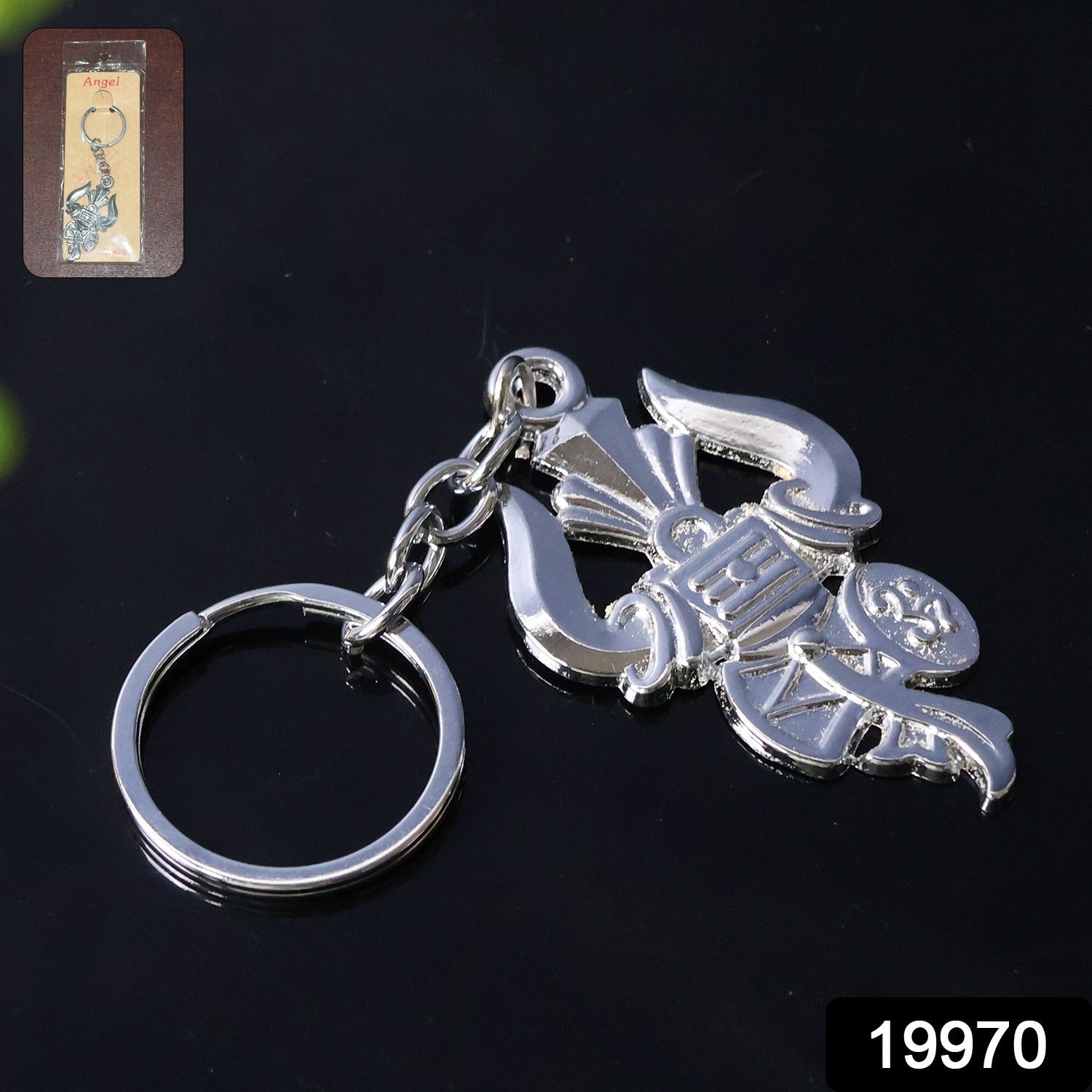 Close-up of intricate silver Trishul and Damru details on keychain