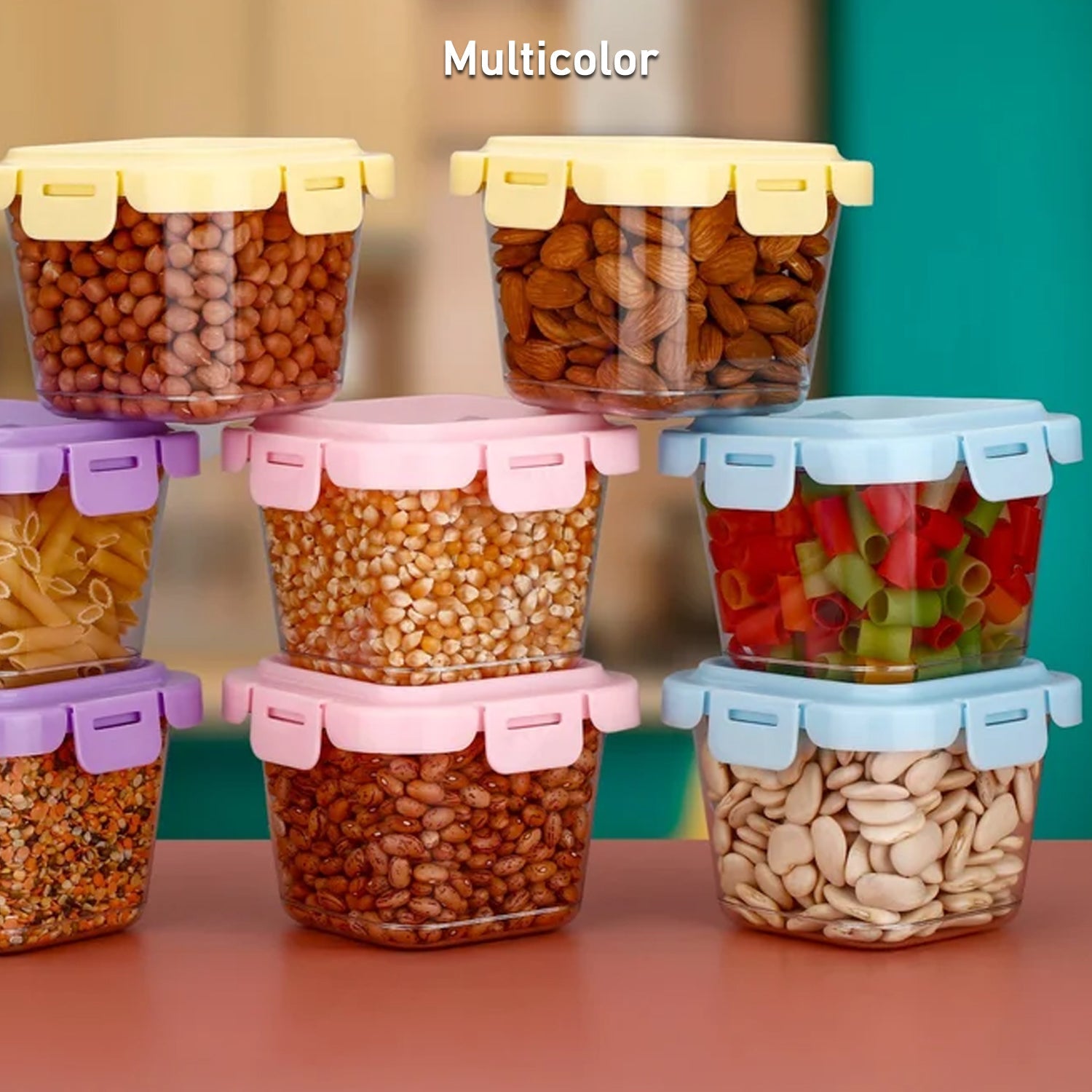 Four colourful 500ml plastic food storage containers with lids, neatly stacked.