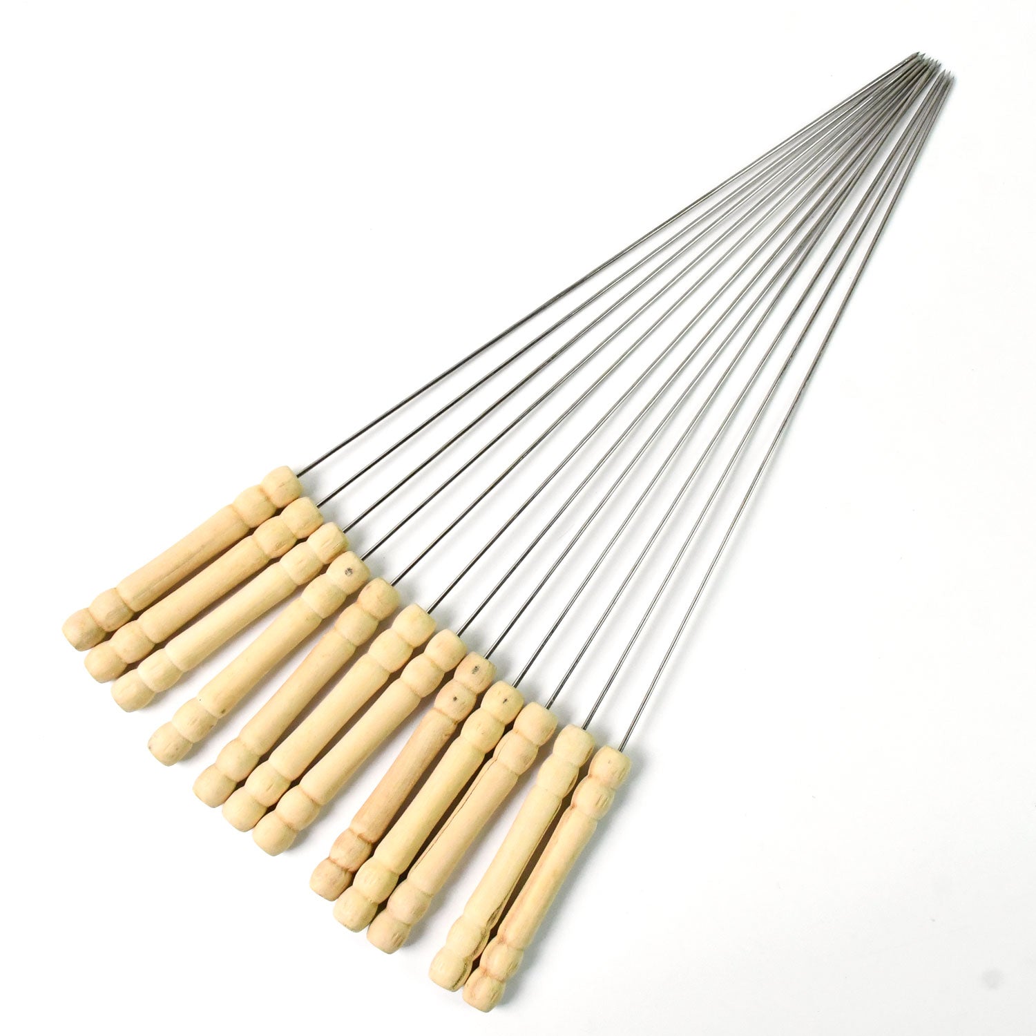 Durable stainless steel skewers laid out ready for grilling on a barbecue.