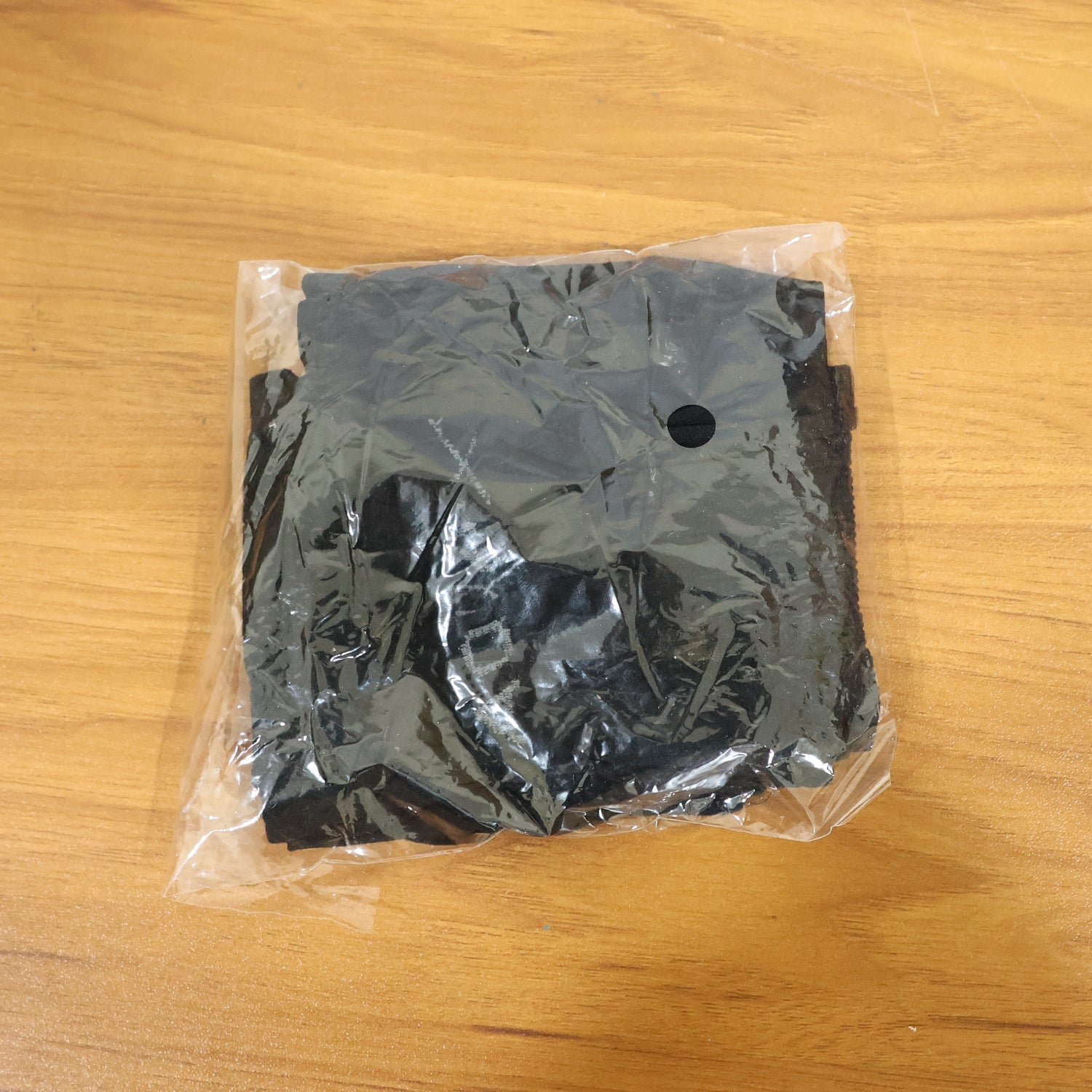 Black pair of compression elbow sleeves folded neatly