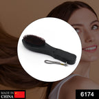 Ergonomic electric hair massager comb showing its vibrating function.