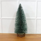Miniature green Christmas tree with snow effect and sturdy wooden base for festive decor