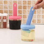 The heatproof plastic spatula with holder, ready for various kitchen tasks.
