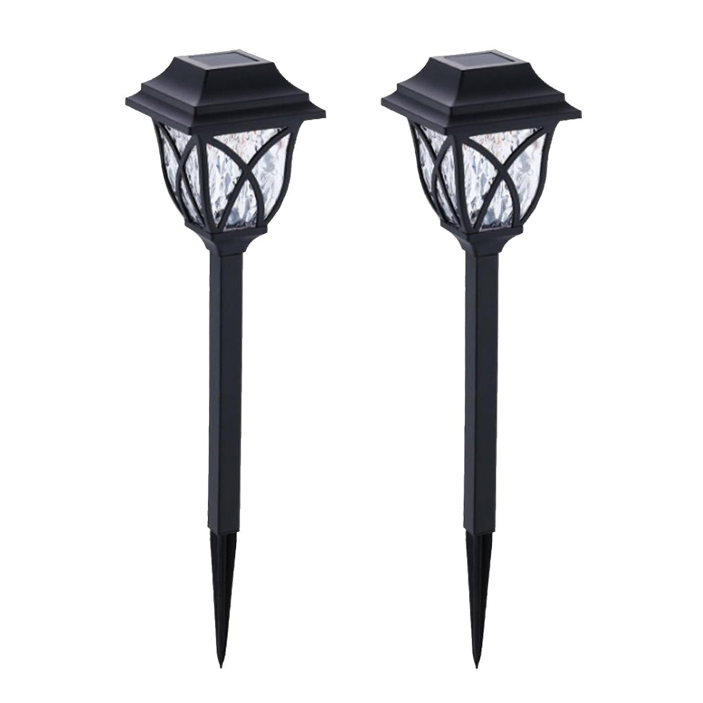 FitFuzion solar pathway lights casting bright, artistic patterns on a dark garden path, enhancing outdoor decor.