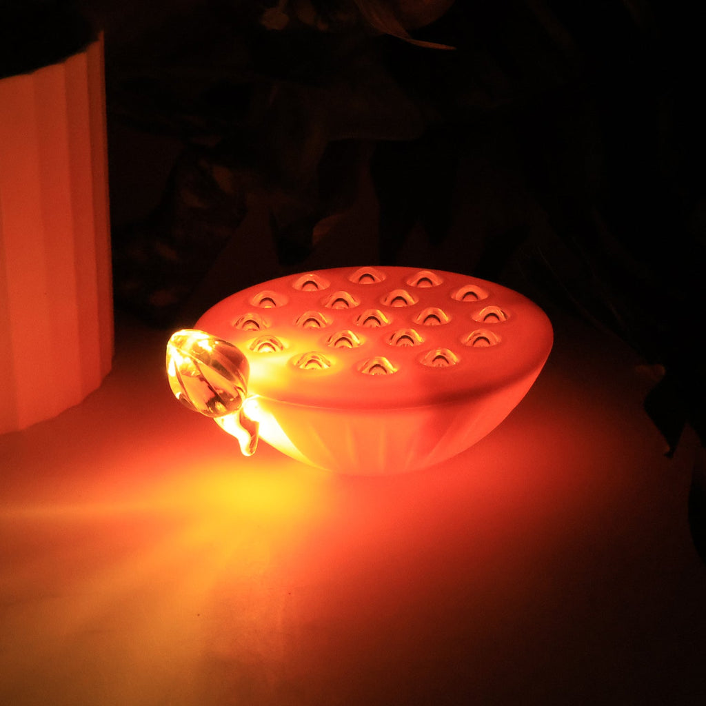 Floating lotus LED decorative lamp glowing softly in water bowl