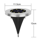 Single solar LED garden light glowing brightly at night in outdoor garden setting