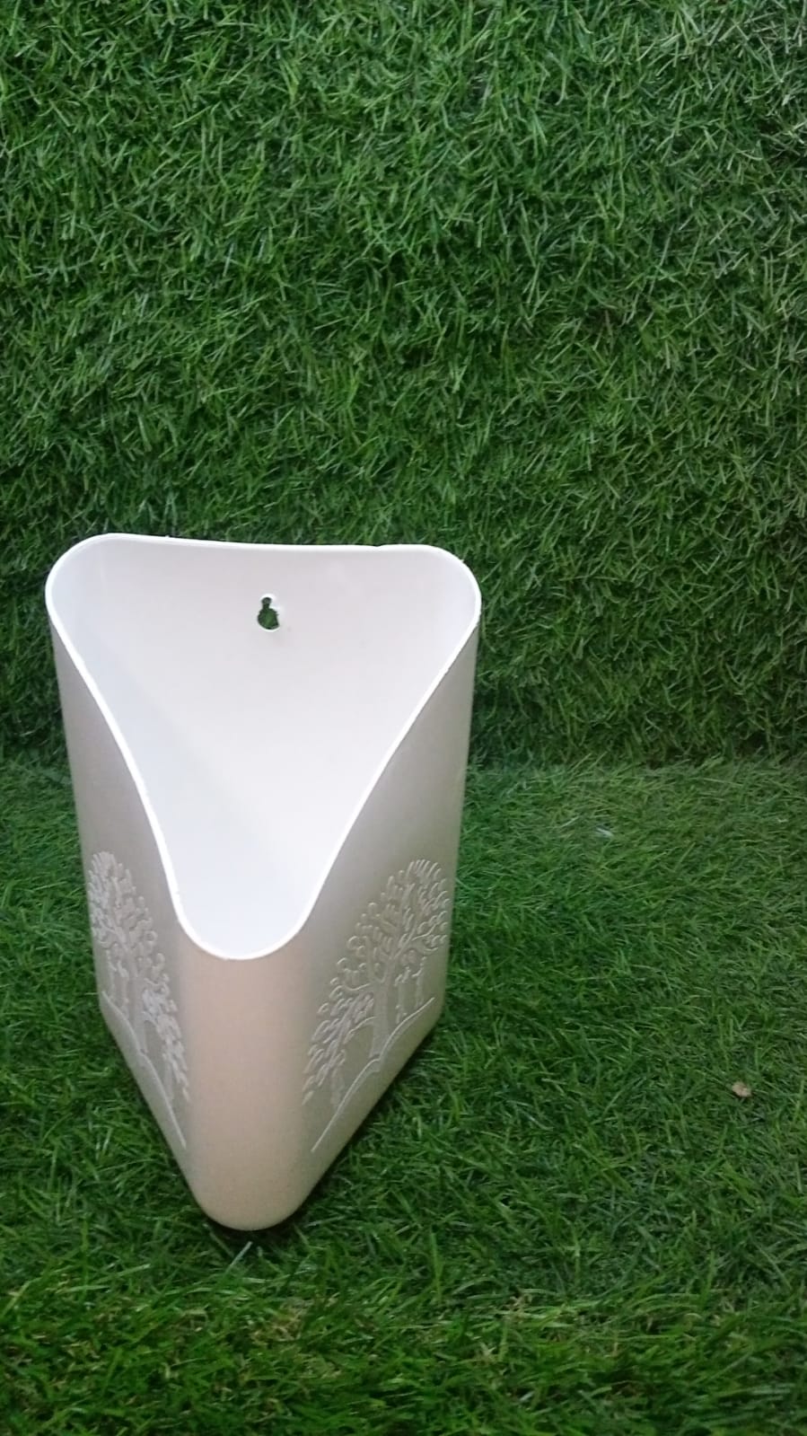 Brightly coloured hanging planter pot for cultivating herbs and small flowers.