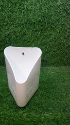 Brightly coloured hanging planter pot for cultivating herbs and small flowers.