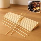 Natural bamboo skewers neatly arranged on a wooden surface.