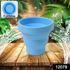 Collapsible silicone travel mug in a vibrant color, ready for use on a clean surface.