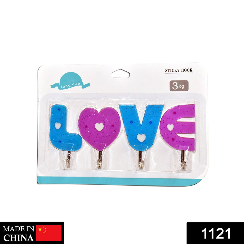 Close-up of heart-shaped wall hooks in white for home organization.