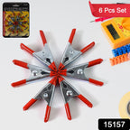 Set of 2-inch metal spring clamps securely holding various objects, demonstrating versatile grip.