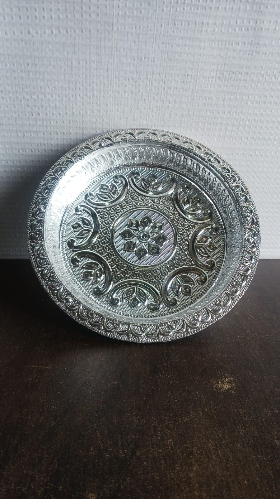 Side view of traditional silver finish lightweight plastic pooja thali