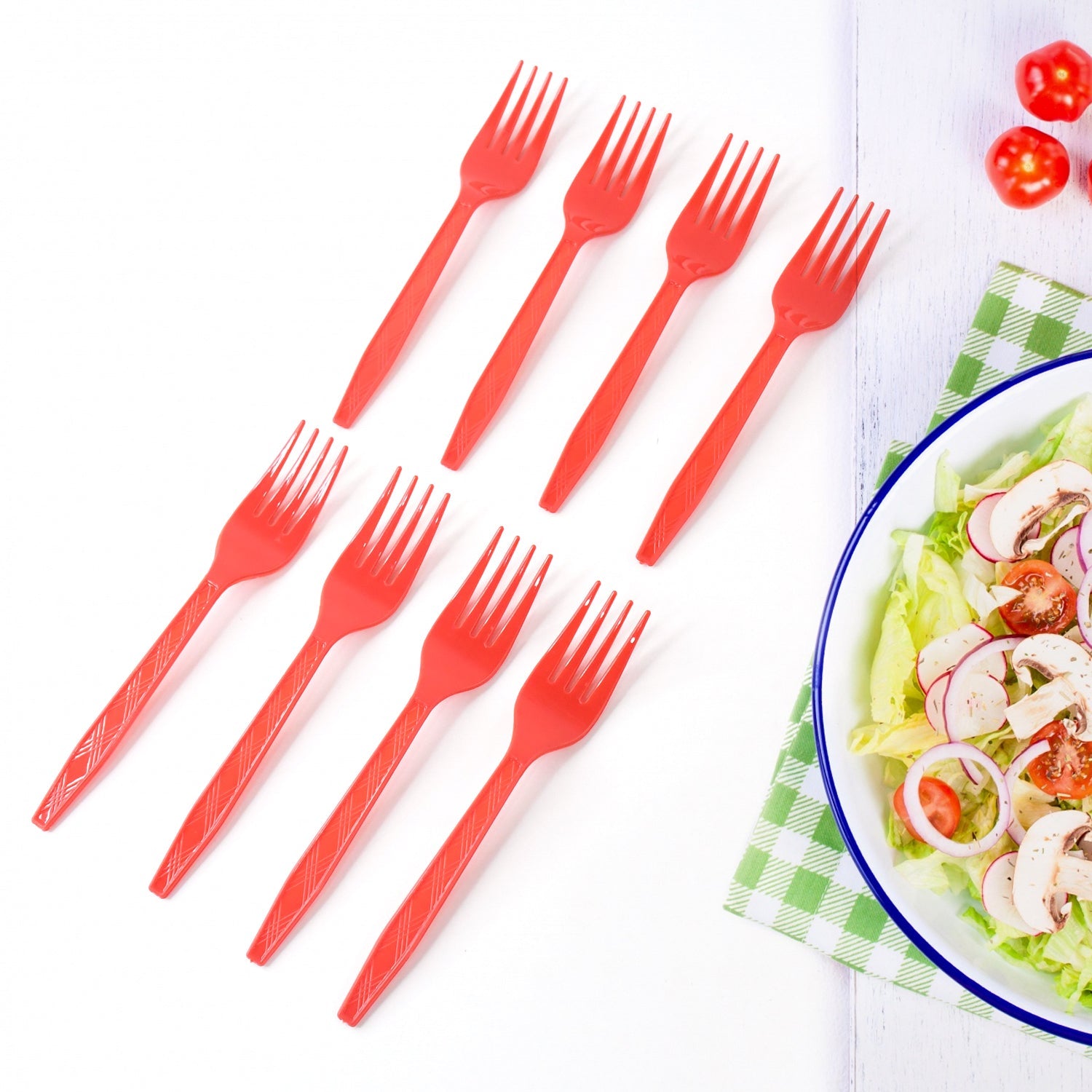 Red disposable plastic forks placed on table setting