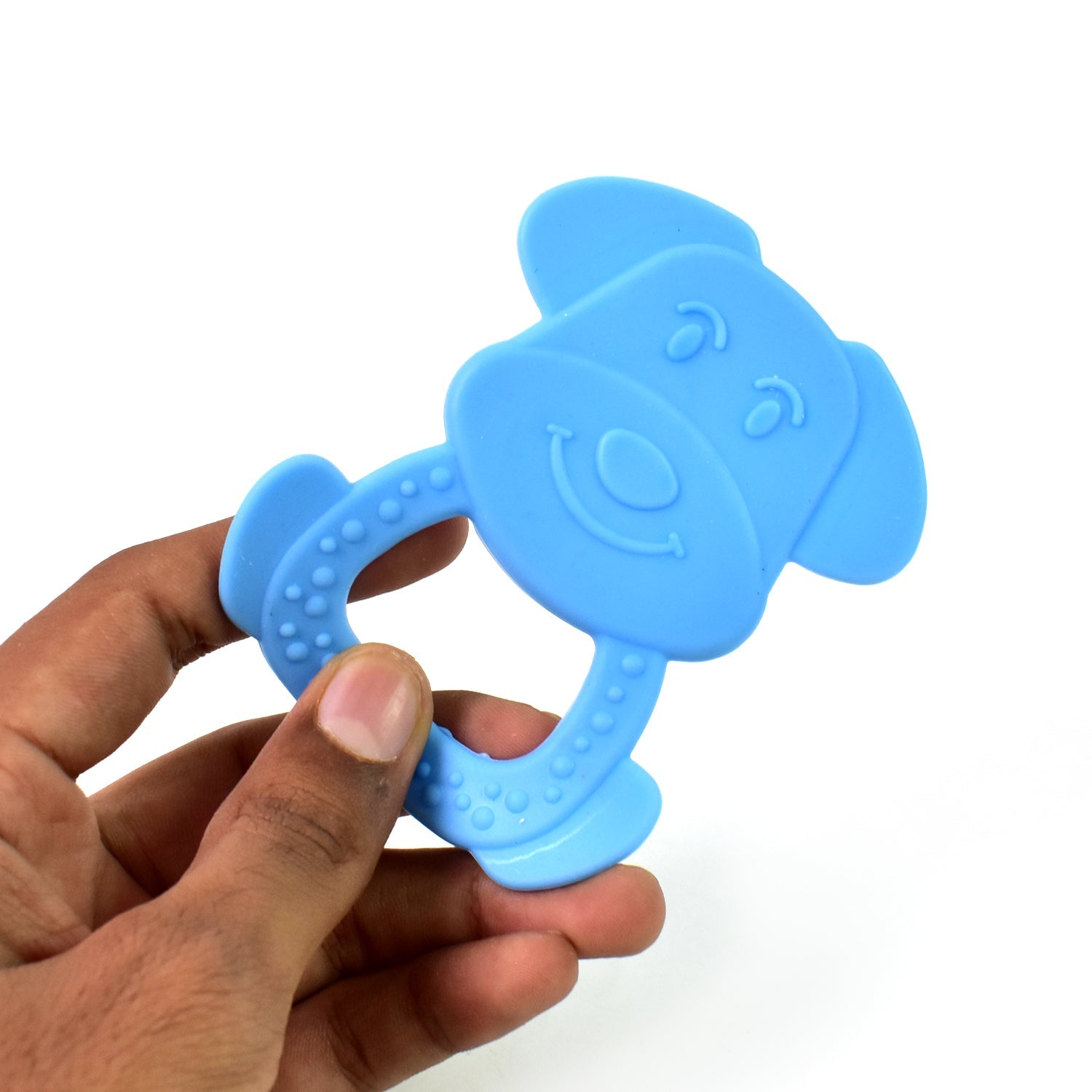 A baby chews on a yellow silicone baby teether, finding comfort during teething.