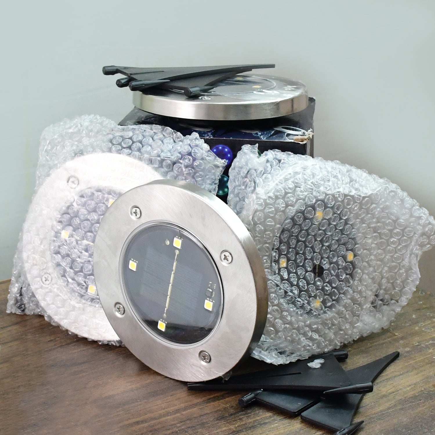 Packaging box containing 4 solar powered LED garden lights for outdoor use