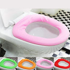 Lifestyle image showing a comfortable, warm toilet seat cover in a modern bathroom setting.