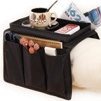Black sofa armrest organizer with a sturdy tray and multiple pockets.