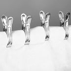 Set of 10 stainless steel clothespins designed for windproof laundry clipping.