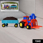 Side view of the durable plastic friction tractor with its detachable trolley on a white background.