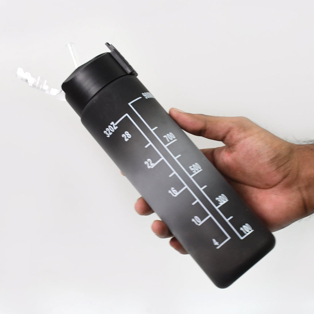 Black Tritan water bottle displaying motivational quotes and capacity markers for daily tracking.