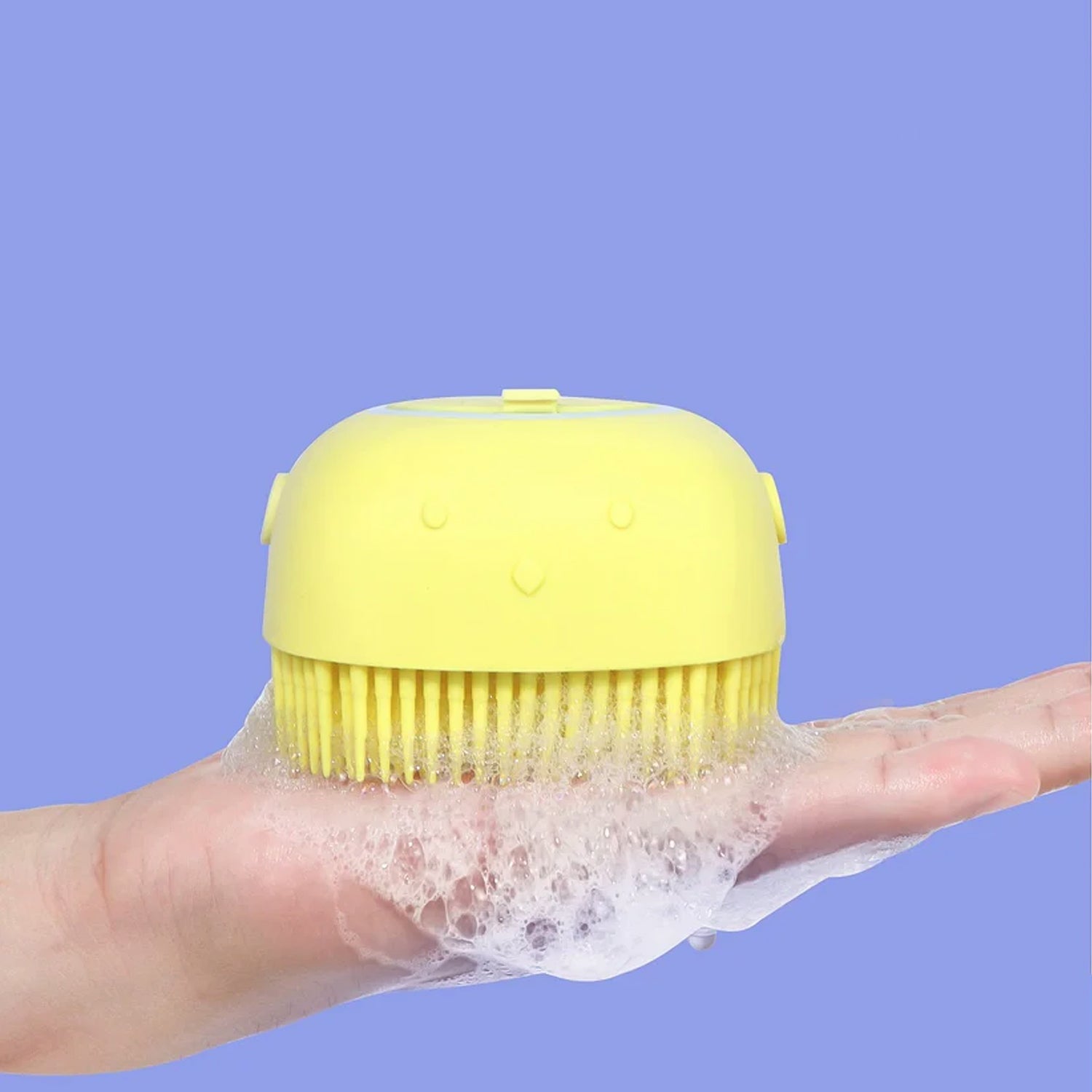 Front view of a soft silicone bath brush with integrated shampoo dispenser.