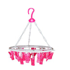Sturdy multicolour round drying hanger with 24 clips, hanging various small items.