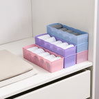 Clear plastic divider tray showing diverse items like beads, buttons, and tiny components.