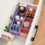Overhead view of a clear plastic organizer filled with vibrant small craft beads.