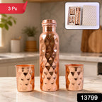 The elegant copper water bottle and two glasses, presented as a thoughtful gift set.