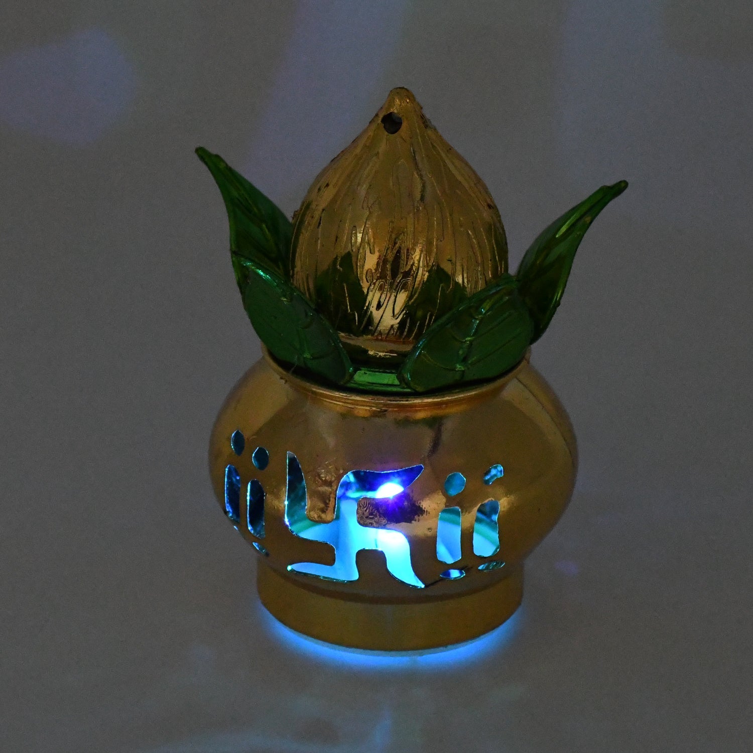 A single gold LED Kalash illuminating a Pooja Mandir setting with a gentle glow.