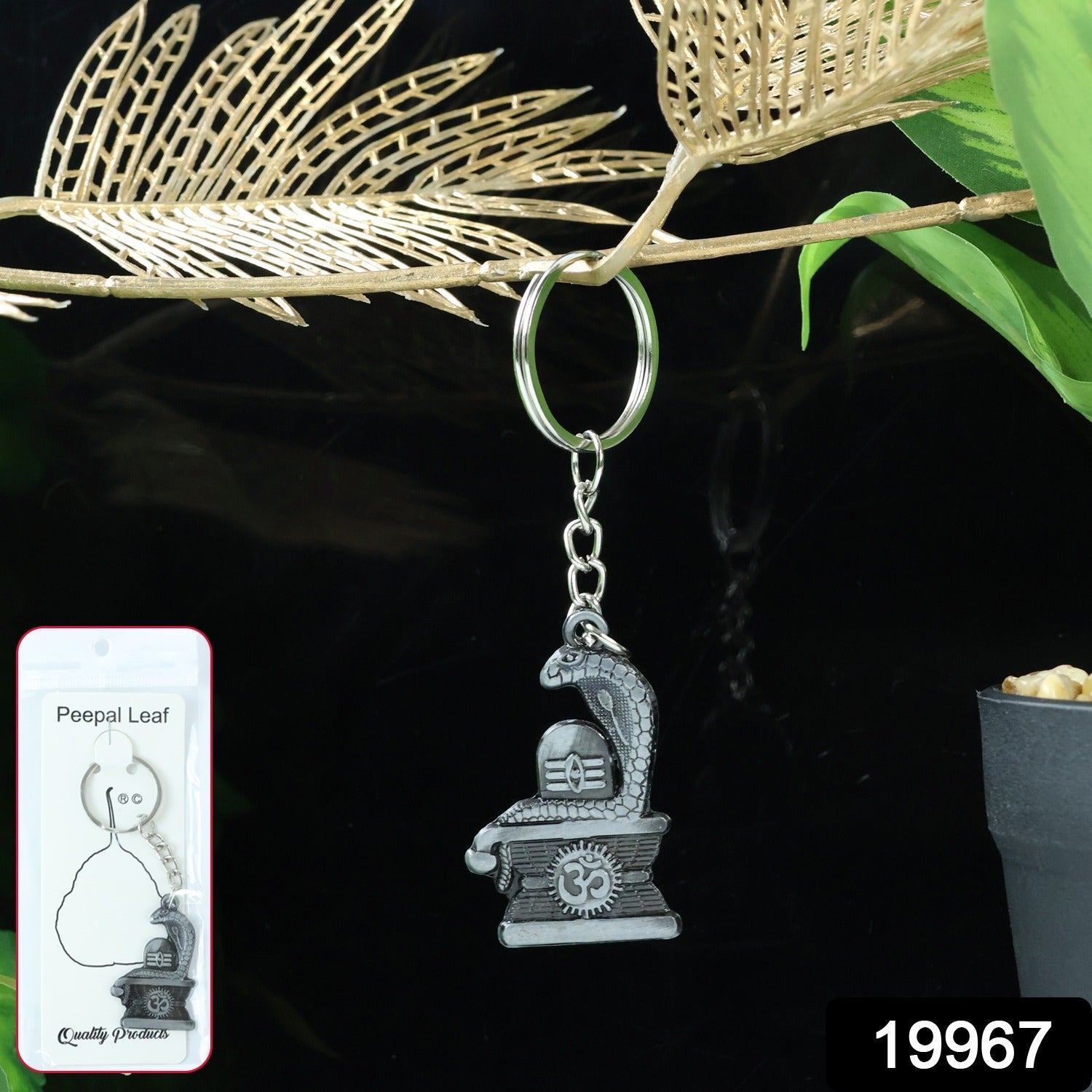 Detailed close-up of silver metal Shivling keychain with snake