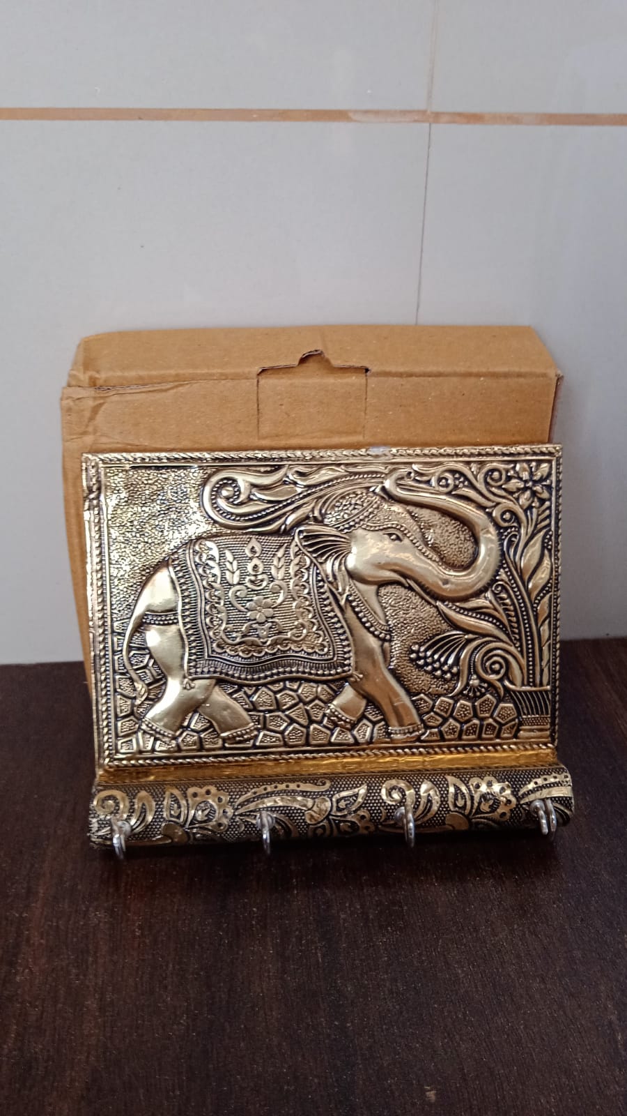 Lifestyle shot of the elegant wooden elephant key holder enhancing a modern home entryway.