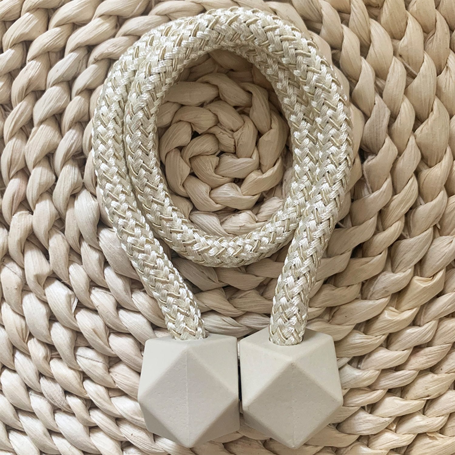Pair of hexagonal magnetic curtain tiebacks elegantly holding a sheer curtain.