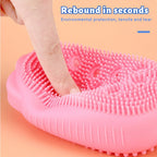 Two silicone body scrubbers, pink and blue, demonstrating color options.
