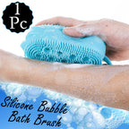 Person using a silicone body scrubber to gently cleanse skin in the shower.