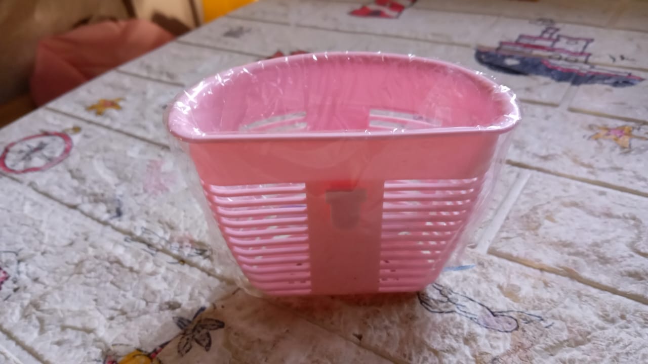 Lifestyle shot of the storage basket in use, holding various household items.