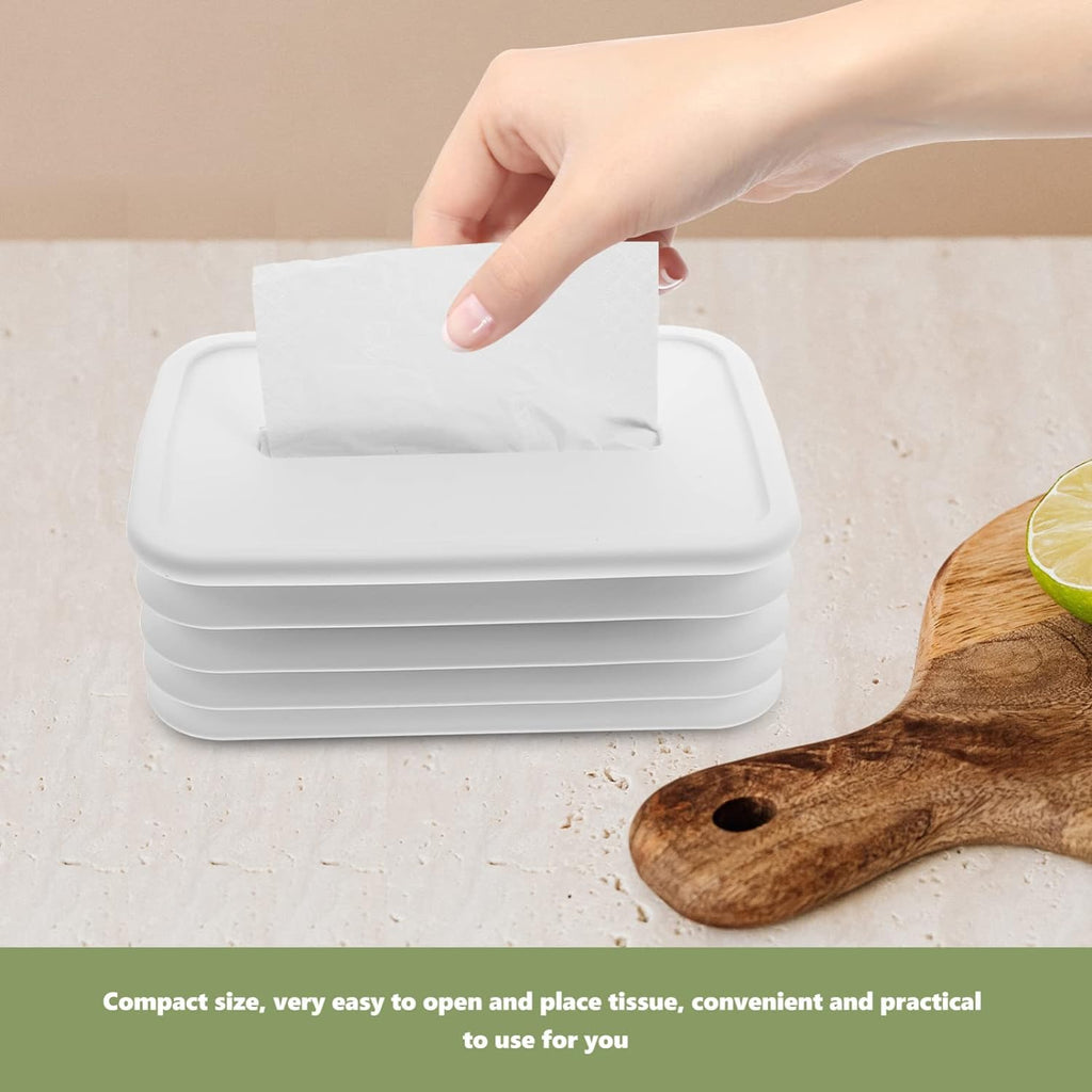 Hand pulling a tissue from the sleek silicone tissue dispenser.