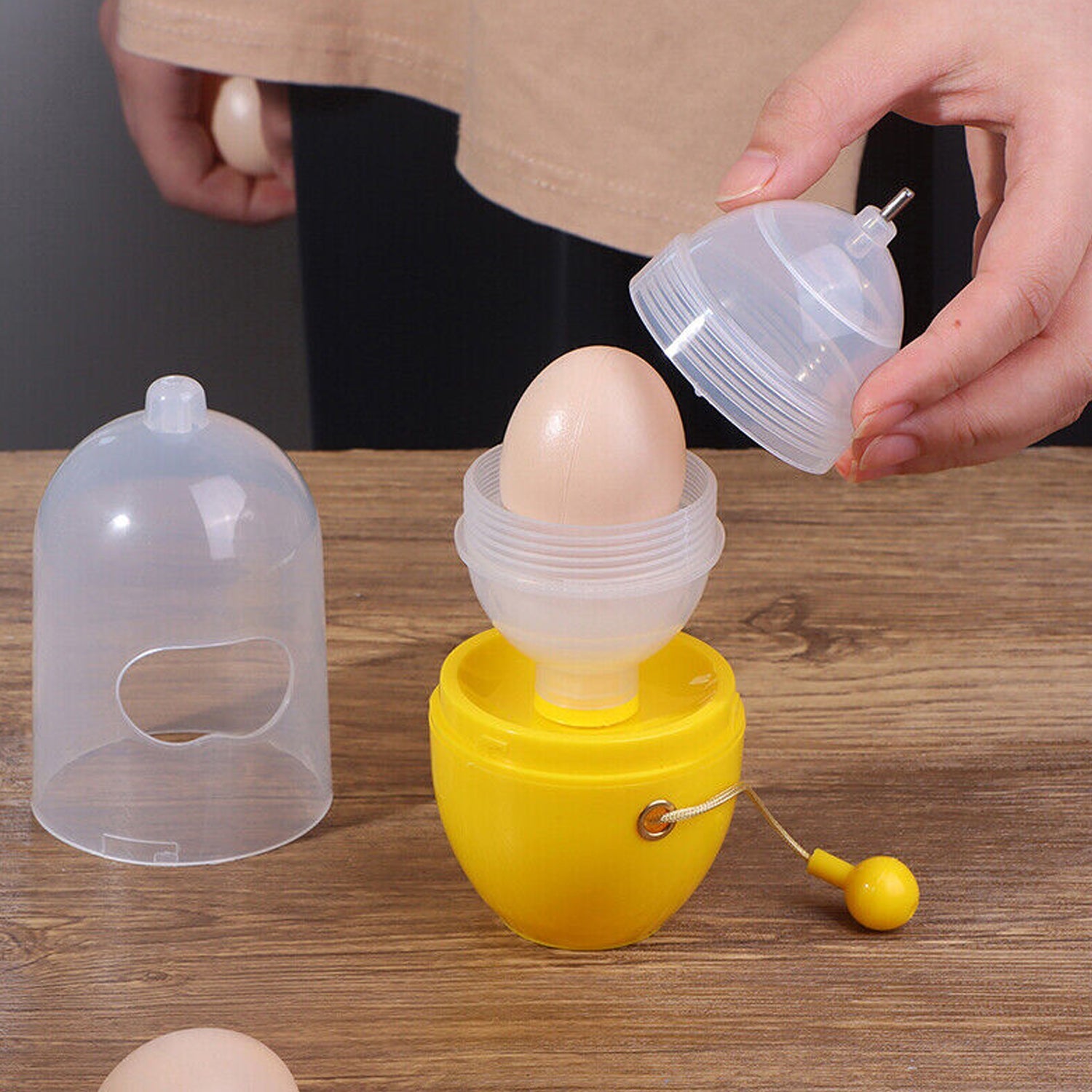 Multiple views of the Storenzo Manual Egg Scrambler, highlighting its white colour and transparent top.