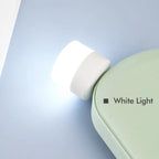 A bright USB bulb providing ambient light for a desk setup in an office environment.