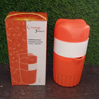 Office water bottle next to the manual citrus juicer, highlighting portability.