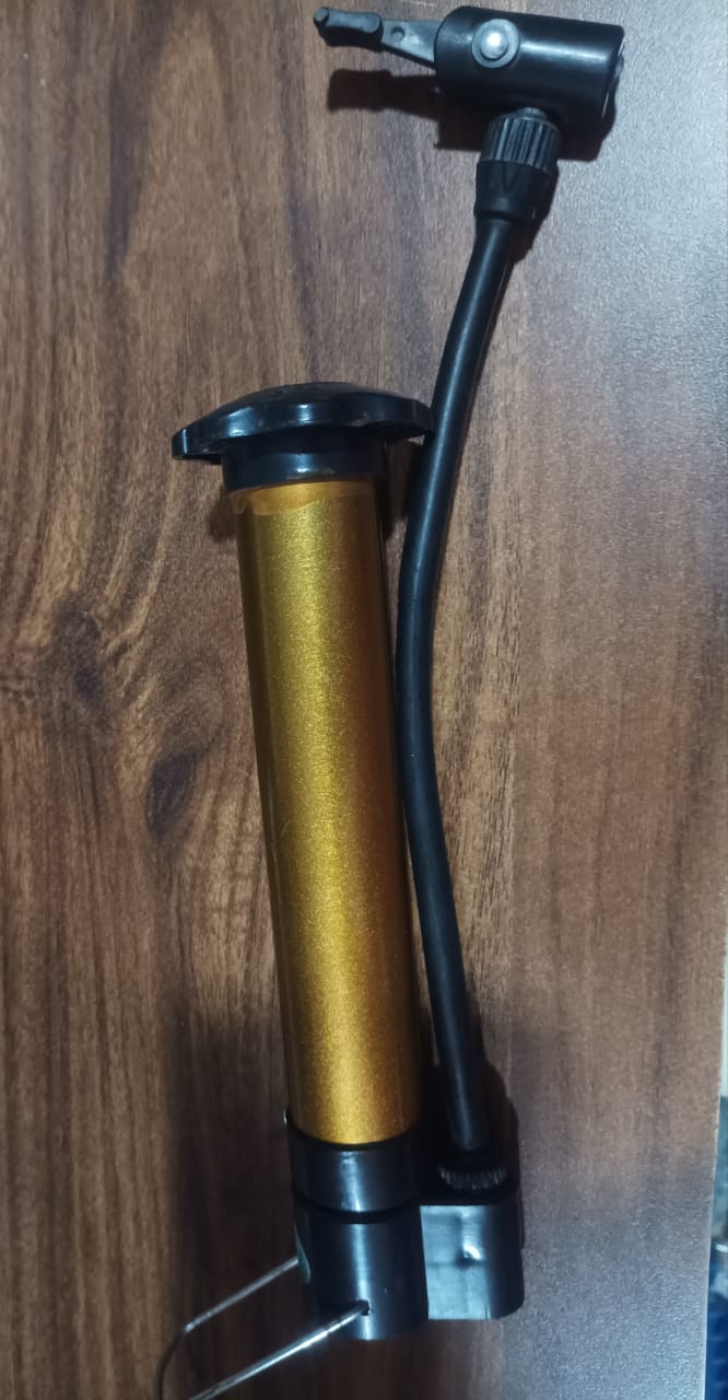 The portable hand air pump with its distinctive gold-plated finish, ideal for all sports enthusiasts.